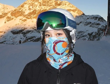 A woman wears a custom neck warmer while skiing